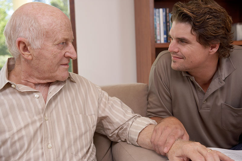 family caregiver helping senior remain calm from dementia aggression