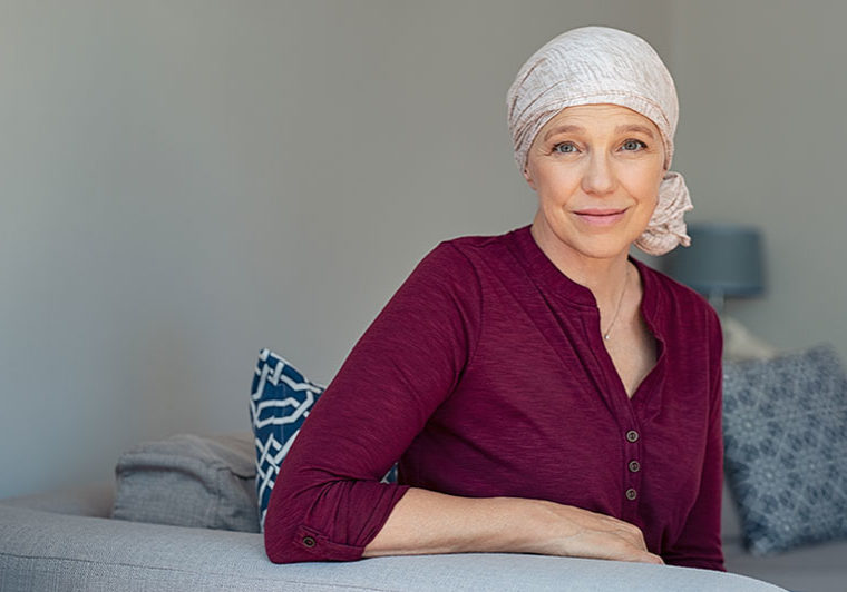 Senior woman with cancer wearing a cover on her head
